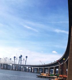 Bridge over sea against sky in city