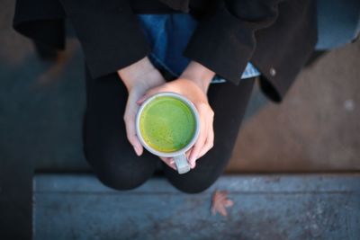 High angle view of hand holding drink