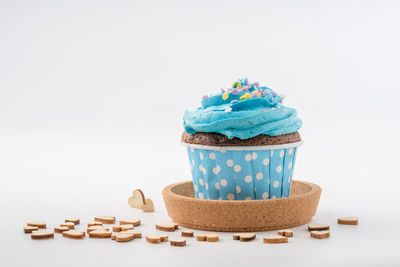 Close-up of cake on table against white background