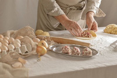 Midsection of man preparing food on table