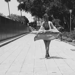 Woman standing on footpath