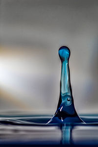 Close-up of drop falling on water surface