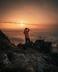 Man photographing at sunset