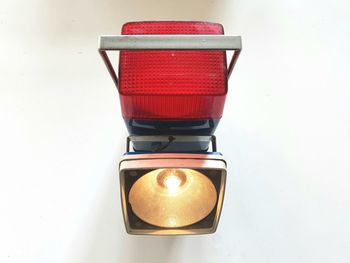 Close-up of illuminated electric lamp on table