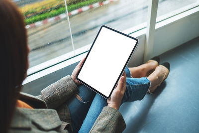 Midsection of woman using mobile phone