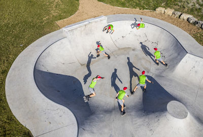 Sportsman skating at skatepool during sunny day