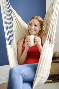 Portrait of a beautiful young woman drinking water