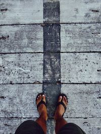 Low section of man standing on footpath