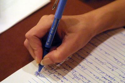 Close-up of hand holding paper