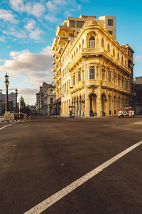 Road by building against sky in city