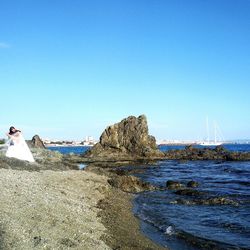 Scenic view of beach against clear blue sky