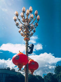 Low angle view of red flowering plant against sky