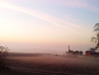 Scenic view of field against sky at sunset