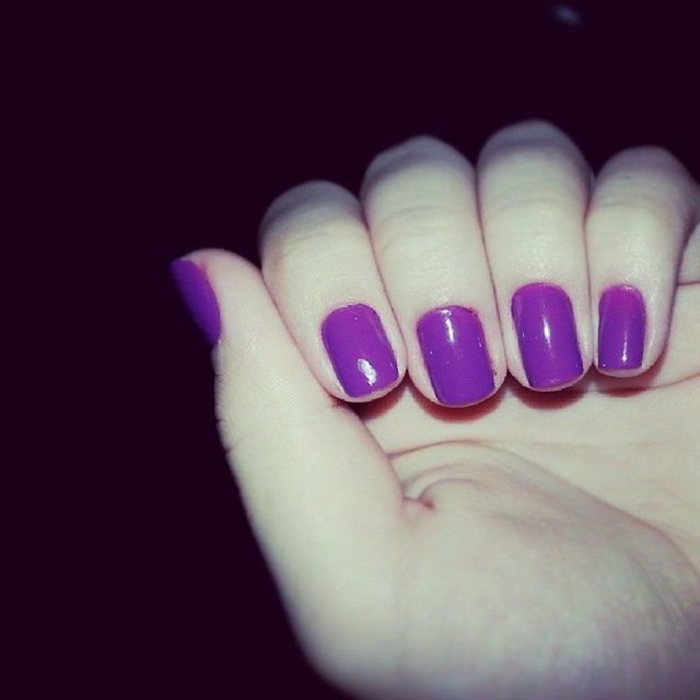 person, part of, human finger, indoors, studio shot, close-up, nail polish, cropped, unrecognizable person, holding, personal perspective, high angle view, blue, black background, purple, multi colored