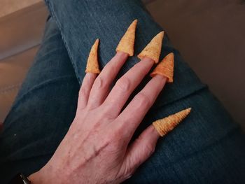 Close-up of hand holding cigarette