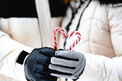 Midsection of man holding heart shape