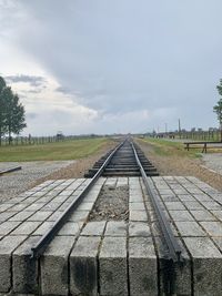 Surface level of railroad tracks against sky