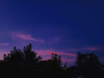 Low angle view of silhouette trees against sky at sunset