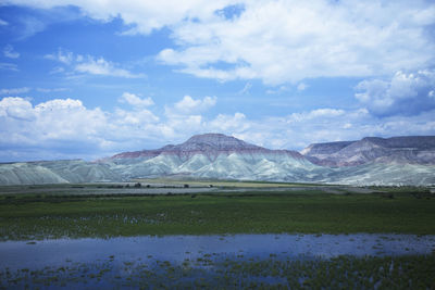 Scenic view of lake and mountains against sky