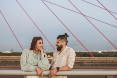 Young couple sitting outdoors