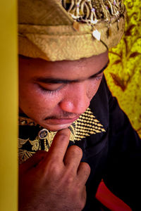 Close-up of man holding hat