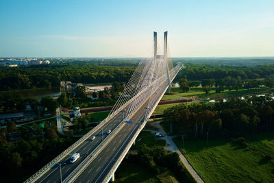 Large cable stayed bridge over river with car traffic, aerial view