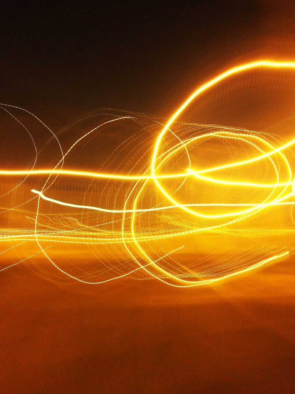 long exposure, orange color, motion, light trail, no people, night, speed, wire wool, illuminated, technology, outdoors, sky, nature, close-up