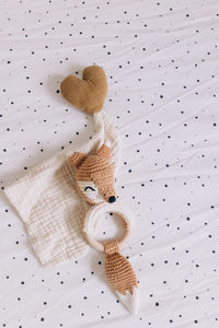 Two small stuffed animals against a white dotted background