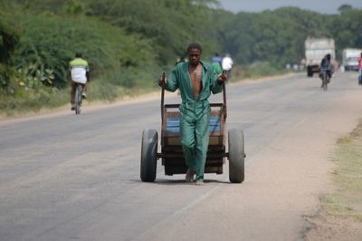 Full length of woman walking on road