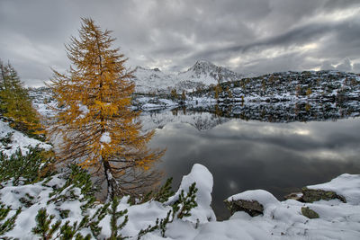 Mountain lake at dusk in autumn with the first snow