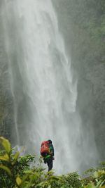 Man looking at waterfall