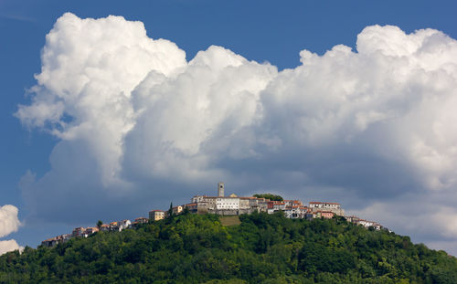 Panoramic view of buildings and trees against sky