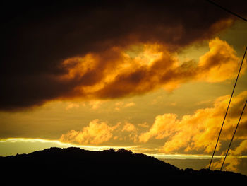 Silhouette trees against sky during sunset