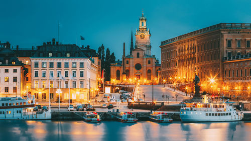 Buildings and harbor against blue sky