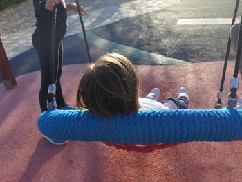 Girl on swing in playground