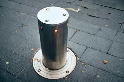 High angle view of electric lamp on sidewalk