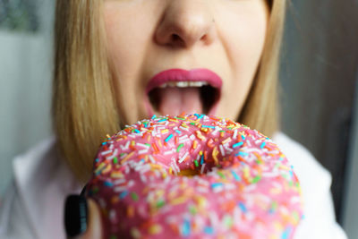 Close-up of young woman holding donut