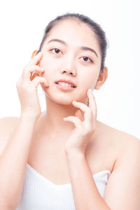 Portrait of a beautiful young woman over white background