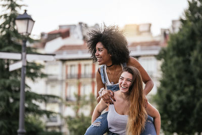 Portrait of smiling young woman in city