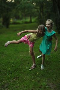 Happy sisters playing on field