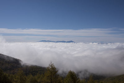 Scenic view of mountains against blue sky