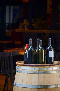 Wine bottles on barrel at restaurant