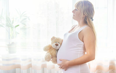 Pregnant woman holding her belly