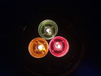 Low angle view of illuminated lamp against dark sky