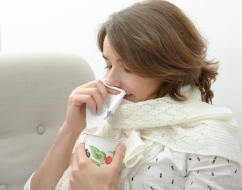 Woman suffering from cold and flu in home