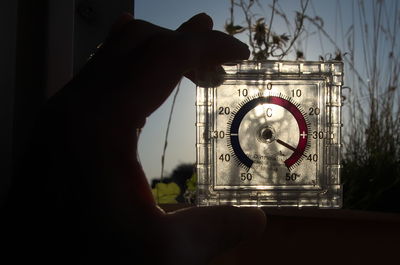 Cropped hand holding clock