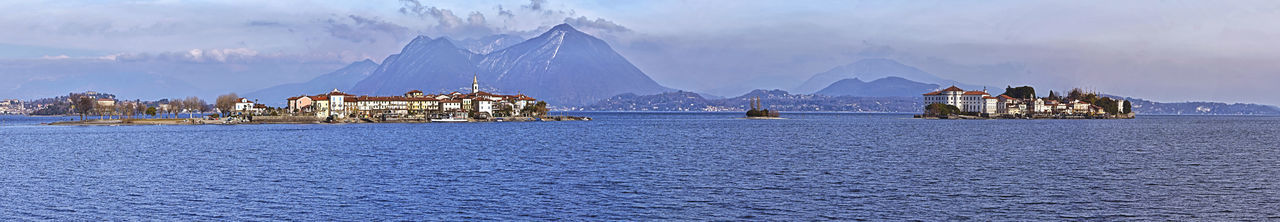 Panoramic view of sea and buildings against sky