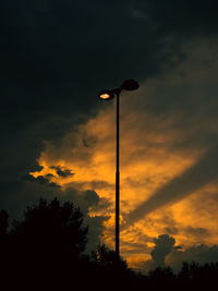 Low angle view of street light against sky during sunset