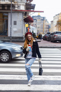 Portrait of young woman walking on street