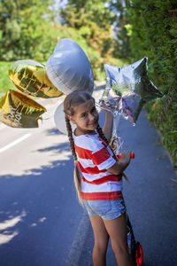 Rear view of young woman standing on street